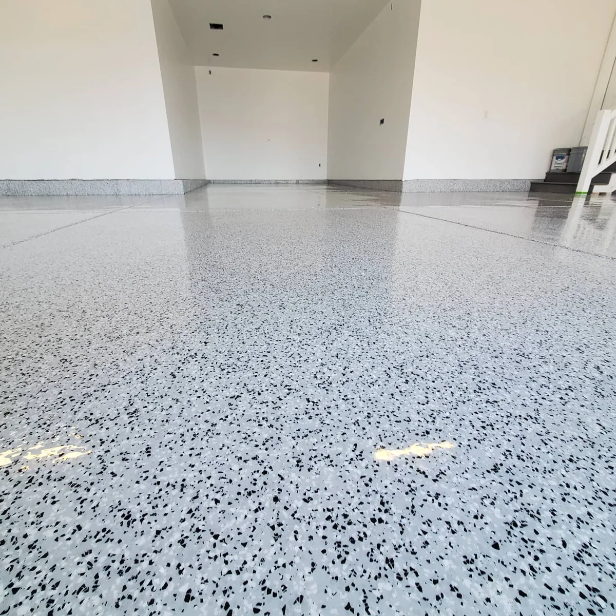 Light decorative flake coating across a garage floor